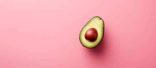 Aufkleber - A fresh avocado seen from above rests on a pink background leaving ample room for other elements in the image