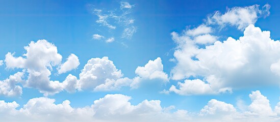 Poster - A bright and sunny day with clear blue skies scattered clouds and ample copy space image