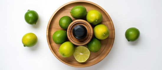 Aufkleber - A top down view of a wooden juicer and fresh limes on a white background providing ample copy space in the image