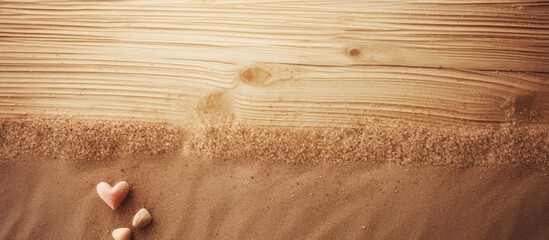 Poster - A romantic Valentines day background with love written in sand in front of a wooden backdrop perfect for product displays Copy space image