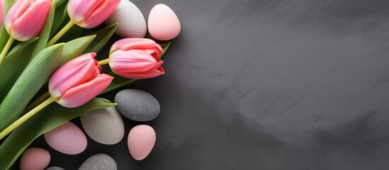 Poster - A copy space image featuring pink tulips and Easter eggs arranged on a stone surface