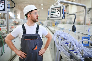 Wall Mural - Portrait of factory worker. Young handsome factory worker