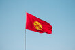 Kyrgyzstan national flag  against blue sky background