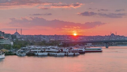 Wall Mural - Many passenger ferries near boat station in the Bosphorus and Golden Horn at sunset timelapse, Istanbul skyline, Turkey. Mosque and bridge on background with reflection on water at spring evening