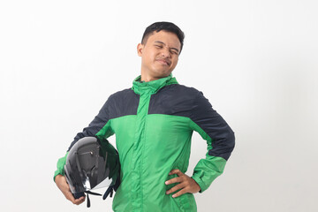 Wall Mural - Portrait of tired Asian online taxi driver wearing green jacket holding a helmet on hip and feeling exhausted. Isolated image on white background