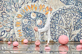 Fototapeta  - Outdoor dance of young ballerina girl with alopecia in white futuristic suit with plastic and flexible movements among pink spheres on abstract mosaic Soviet background, symbolizes self expression