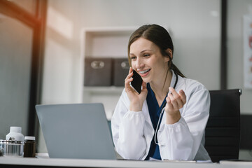 Wall Mural - Female medicine doctor, physician or practitioner involved in cellphone call conversation giving professional consultation to patients. Medic tech concept.