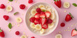   Bowl of oatmeal with sliced bananas strawberries on pin background for Weight loss and healthy eating concept.  diet plan in a Healthy eating, dieting
