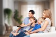Positive young family with kid taking on cozy couch