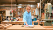 © Monkey Business - Female Carpenter Working In Woodwork Workshop With Cup Of Coffee Making Notes On Clipboard