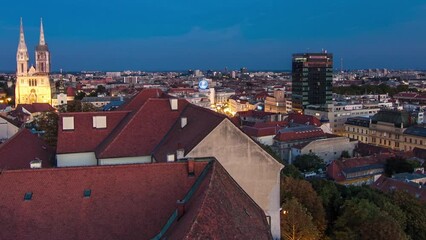 Wall Mural - Kaptol and catholic cathedral day to night transition timelapse in the center of Zagreb, Croatia, panoramic top view of downtown from Kula Lotrscak tower after sunset