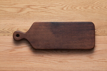 Sticker - Wooden cutting board. Handmade wooden cutting board on oak tabletop.