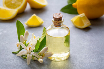 Wall Mural - Fresh citrus essential oil. Lemon oil bottle with lemons fruits