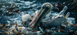 A pelican swims in a pond surrounded by plastic waste and other debris. The concept of environmental pollution