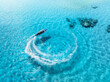 Aerial view of the speed boat in clear blue water on summer sunny day. Top drone view of fast floating yacht in ocean ocean. Travel in Zanzibar. Tropical landscape with motorboat on the sea. Travel