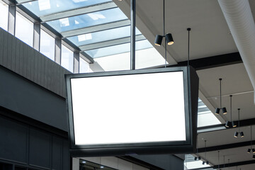 Wall Mural - Blank white mockup background texture of a large, rectangular digital screen hanging from the ceiling of a building interior, or a shopping centre. Empty commercial ad copy space for your design.