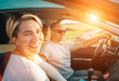 © Soloviova Liudmyla - Portrait of cheerful smiling young woman with husband have auto journey inside modern car. Safety riding car, car sharing and traveling concept image.