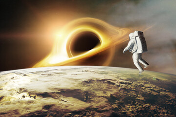 Wall Mural - spaceman looks at black hole on low-orbit of earth planet. elements of this image furnished by nasa.