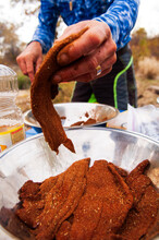 A Man Prepares Breaded Catfish At A Camp Along The Mississippi River.