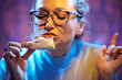 Adult teacher woman with glasses enjoys eating pizza during lunch break