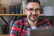 Close up shot of mature businessman freelancer man student wearing eyeglasses while using laptop in home office workplace coworking . Working remote concept