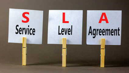 Wall Mural - SLA service level agreement symbol. Concept words SLA service level agreement on beautiful white paper. Beautiful grey background. Business SLA service level agreement concept. Copy space.