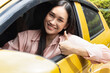 Happy smiling and relaxed woman driver drives with accepting thumb up, concept image for low gasoline price, good traffic condition, new car, passing driver license, taxi app, Right-side driving