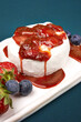 Brie or camembert cheese with strawberry, blueberry and bread on blue background. French appetizer