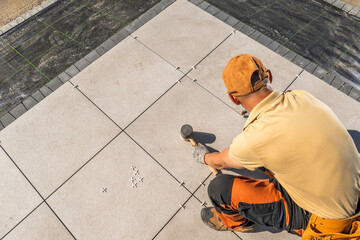 Wall Mural - Man Laying Tile on Concrete Garden Patio Floor