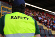 © ChiccoDodiFC - stadium security guard wearing a uniform with the word SAFETY standing among the spectators in the stands