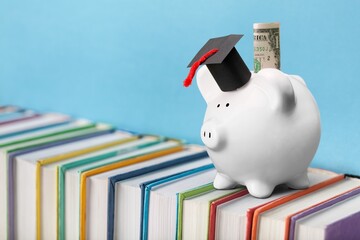 Wall Mural - Graduation hat on piggy bank with coins