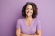 © Markus Schröder - Portrait of a cheerful woman in her 40s with arms crossed in pastel purple background