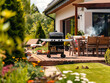 © Thomas Meinert - Eine schöne Gartenterrasse an einem Haus mit modernen Gartenmöbeln. BBQ im Garten