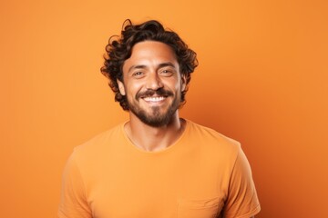 Canvas Print - Portrait of a cheerful man in his 30s smiling at the camera in pastel orange background