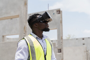 African American male construction engineer wearing virtual reality headset inspecting quality of structural at construction site. Male construction engineer working with VR headset at site work