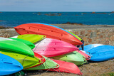 Fototapeta Desenie - Colorful sea kayaks on the shore in Cobo bay, Guernsey, CHannel Islands