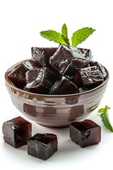 Delicious grass jelly cubes in bowl on white background