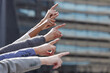 © peopleimages.com - Business, diversity and people with hands pointing, direction and outdoor or building development idea and together. Collaboration, team and company employees, support and mission or finger gesture