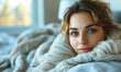 © Bartek - Sick Young Woman Wrapped in a Cozy Blanket in Bed, Gazing at Camera with a Wearied Expression on a Sunlit Morning