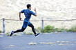 © peopleimages.com - Man, running and exercise with speed on path in summer for fitness and training in cardio for marathon. Athlete, workout and healthy journey outdoor on countryside road with fast sprint and runner