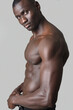 side view of a portrait of shirtless man look at camera