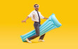 Funny bearded man wearing office clothes with shirt and tie holding inflatable mattress and having fun isolated on yellow background. Happy tourist is going on summer holiday trip. Vacation concept.