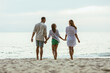 Family Walking on Beach Holding Hands