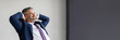 © Prostock-studio - Smiling middle aged businessman leaning back in chair at workplace in office, handsome happy entrepreneur in suit sitting at desk with hands behind head, resting after successful day, copy space