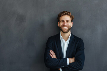 Wall Mural - A smiling businessman exudes confidence against a gray backdrop, with ample copy space.