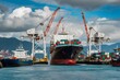 Busy port with cargo ship, cranes, smaller vessels, mountains, clouds, bustling scene