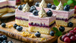 Berry mousse cakes with whipped cream and blueberries on a wooden board.