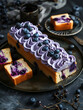 Elegant blueberry loaf cake, beautifully decorated with swirls of purple cream.