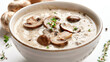 Creamy mushroom soup with wild mushrooms and thyme, on a white background