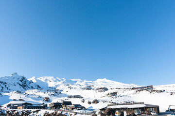 Canvas Print - Big blue sky over Whakapapa ski-field as sun rises behind the mountain